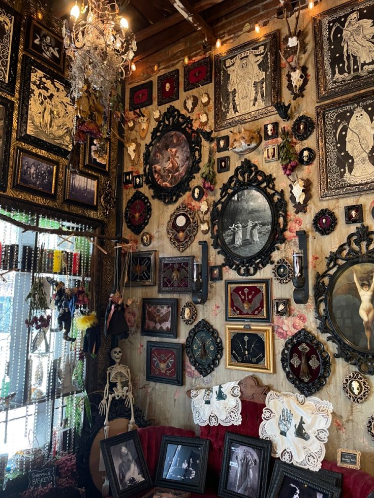 a room filled with lots of framed pictures and clocks