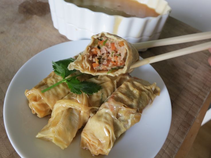 a white plate topped with dumplings and vegetables