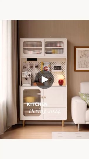 a white couch sitting next to a kitchen cabinet