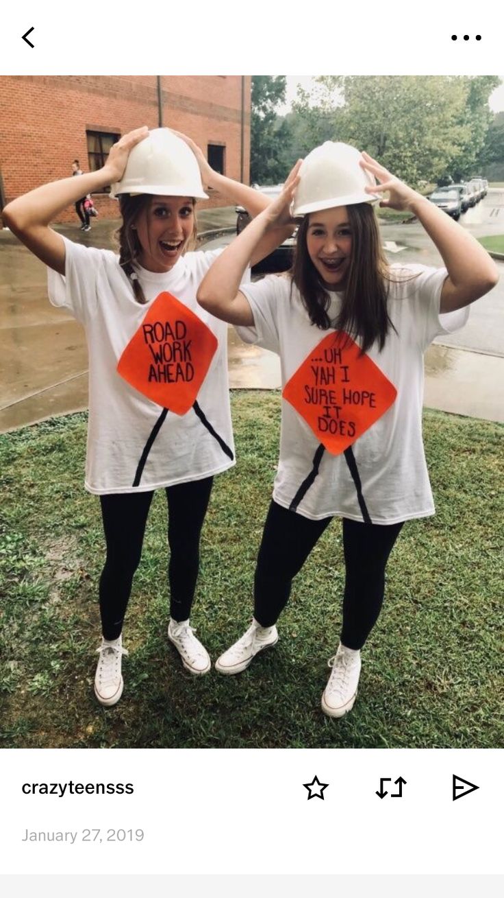 two girls wearing hard hats and t - shirts with road work ahead signs on them