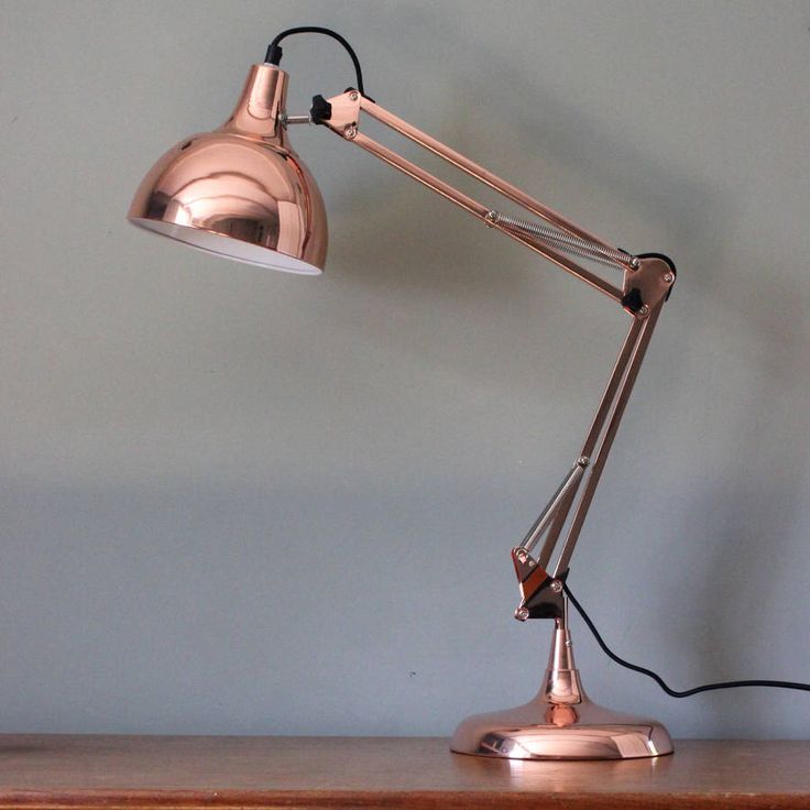 a desk lamp sitting on top of a wooden table