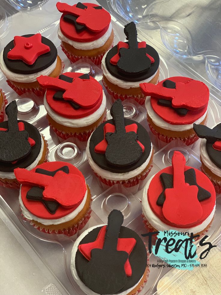 cupcakes with red and black frosting in a plastic container