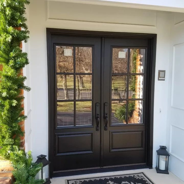 a black double door with two sidelights