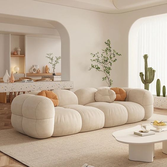 a living room filled with furniture and a cactus