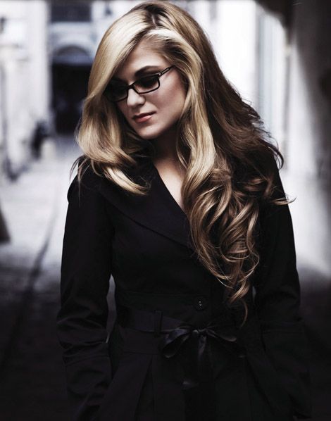 a woman with long blonde hair and sunglasses