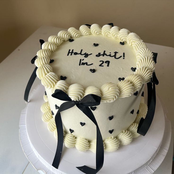 a birthday cake with white frosting and black hearts on it that says happy 21st in 22