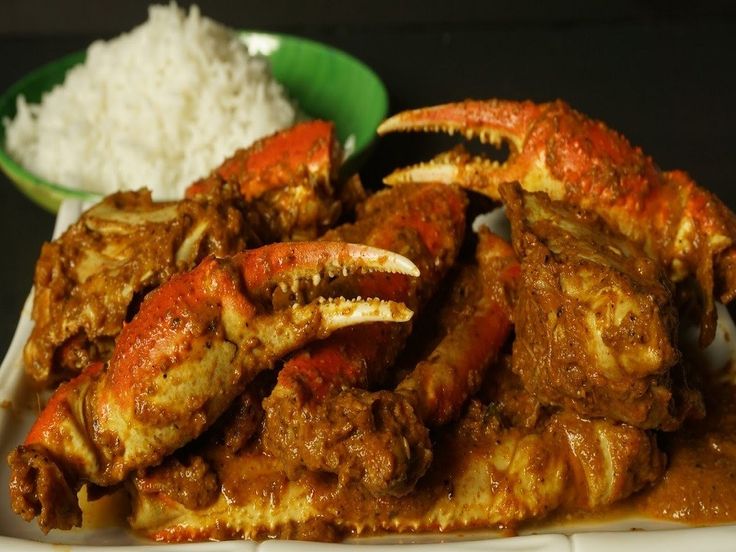 cooked crab legs and rice on a plate