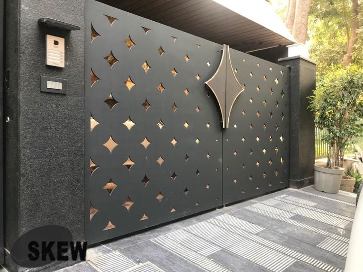 a black and gold gate on the side of a building