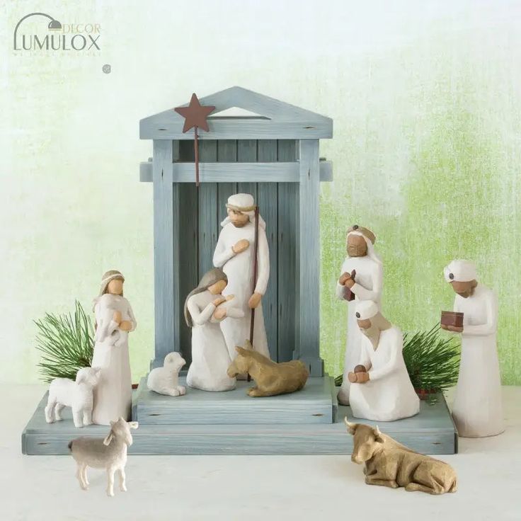 a nativity scene with figurines of people and animals in front of a small shrine