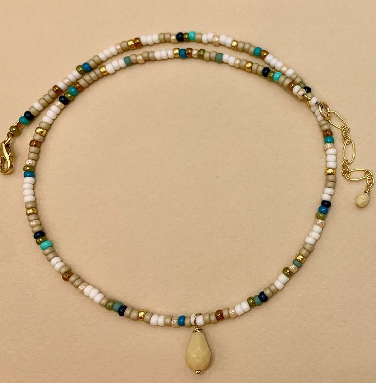 a necklace with beads and charms on it