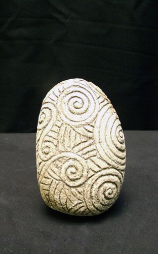 a white stone sitting on top of a black table