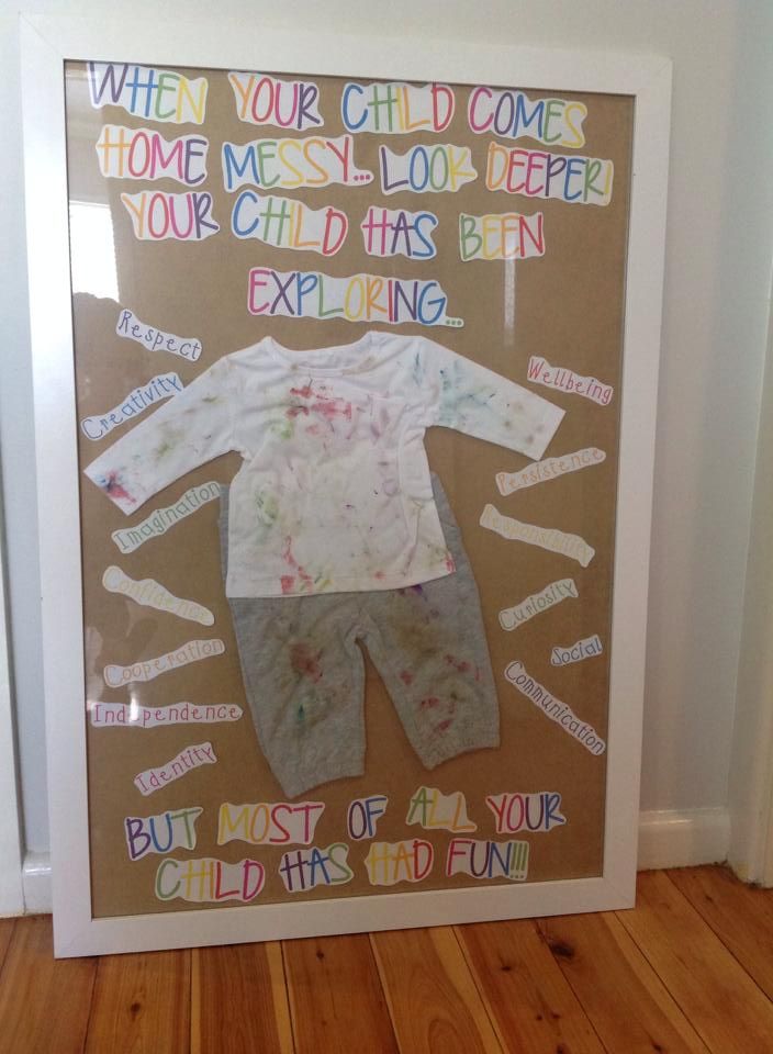 a child's paper cutout is displayed in front of a door with words written on it