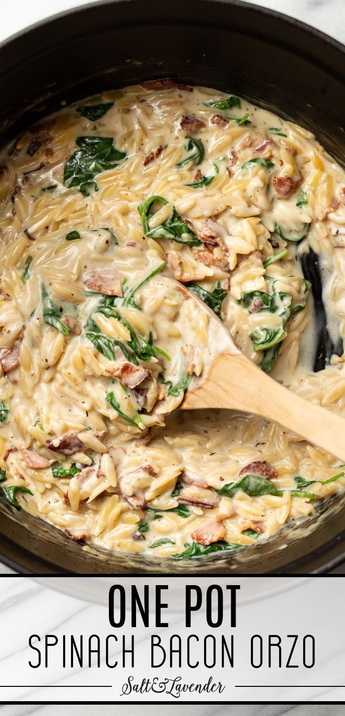 one pot spinach bacon orzo in a skillet with a wooden spoon