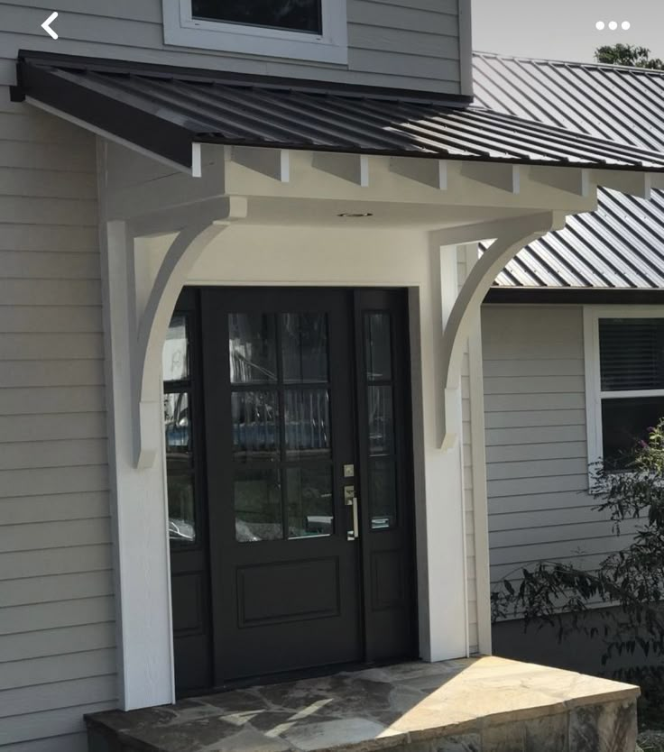 a house with a black front door and white trim