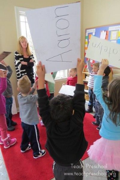 a group of children holding up signs in the air