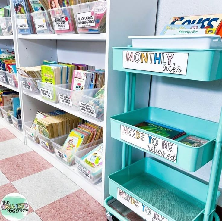 there is a blue cart with books on it in the store and some shelves full of children's books