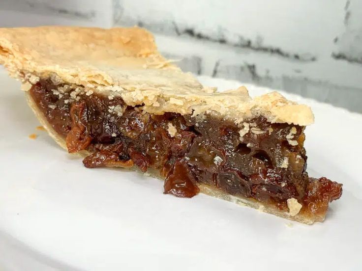 a piece of pie sitting on top of a white plate