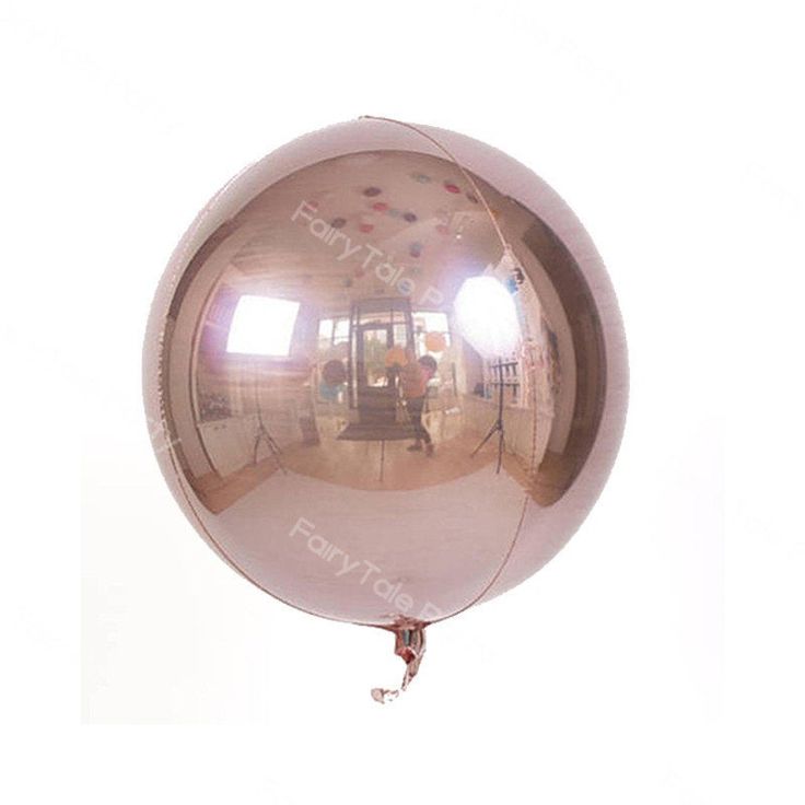 the reflection of a person sitting in a chair on a balloon