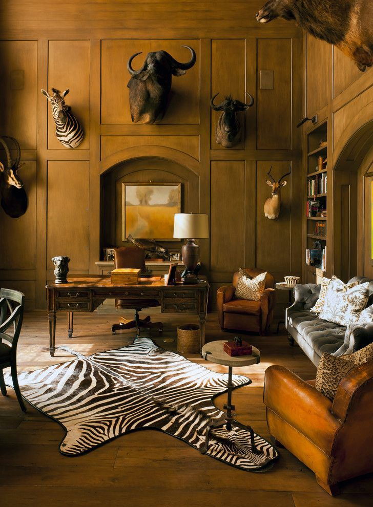 a living room filled with lots of furniture and animal heads