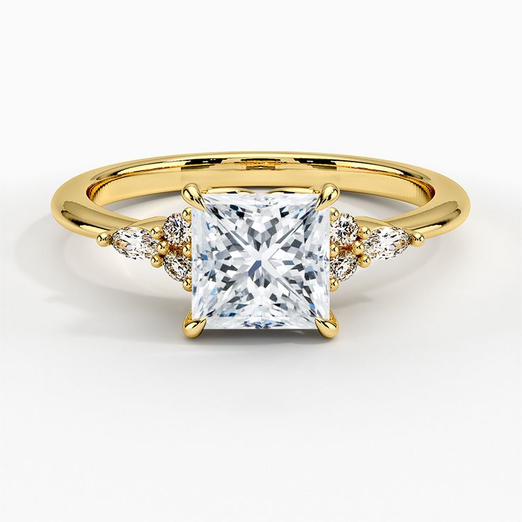 an engagement ring with a princess cut diamond in the center and side stones on each band