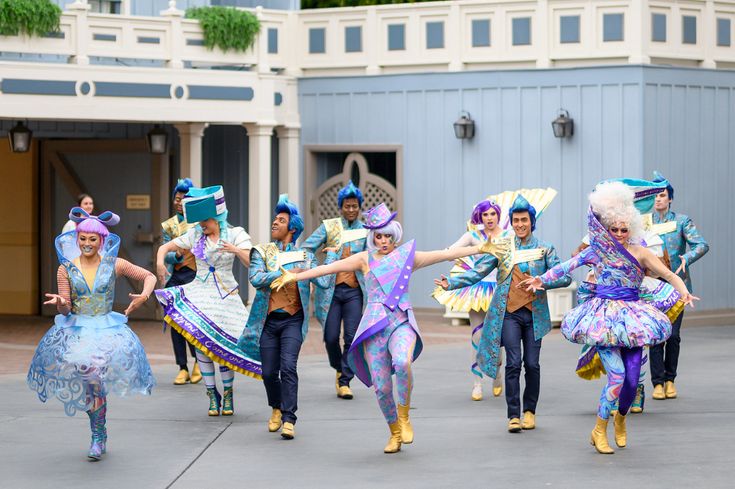 a group of people that are standing in the street with some kind of costume on