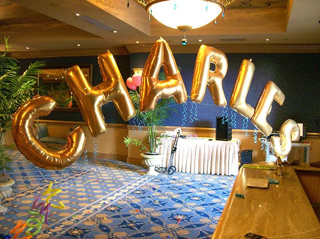 the letters and numbers are made out of gold foil balloons, which spell out alphabets