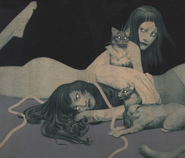 a woman laying on top of a bed next to two cats and a cat sitting on her stomach