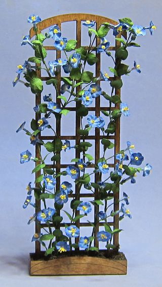 a wooden chair with blue flowers growing out of it