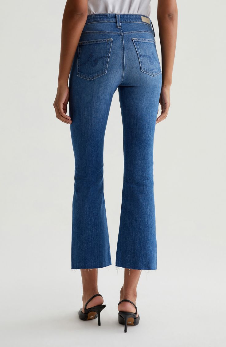 A faded wash and raw hems bring cool, casual appeal to mid-rise cropped bootcut jeans cut from comfortable cotton-blend stretch denim. 27" inseam; 16" leg opening; 10 1/2" front rise; 14" back rise (size 29) Zip fly with button closure Five-pocket style 98% cotton, 2% elastane Machine wash, tumble dry Imported Casual Flared Hem Jeans With Frayed Detail, Medium Wash Flared Hem Jeans For Spring, Spring Medium Wash Flared Hem Jeans, Spring Flared Hem Jeans With Frayed Edge, Casual Medium Wash Jeans With Flared Hem, Medium Wash Jeans With Frayed Flared Hem, Casual Summer Jeans With Flared Hem, Casual Flared Hem Jeans For Summer, Faded Washed Cropped Flare Jeans