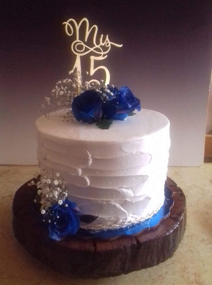 a white cake with blue flowers on top