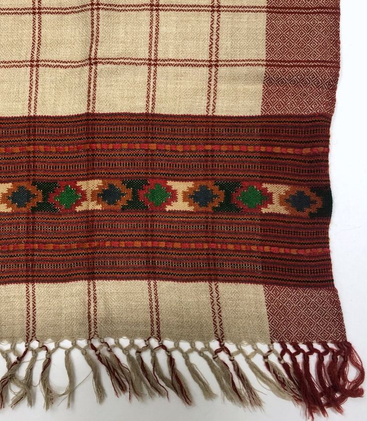 This collection of scarves for Gadabout Goods was handmade by women in the Kullu Valley of the Indian Himalayas. Sourcing wool from local small farmers, each wool scarf was hand loomed in traditionally inspired Kullu patterns. Each pattern is extremely limited. On closer look, this beautiful scarf has a detailed diamond weave within the main colors, and a line of raised weave on the top and bottom of its border design. We hope you enjoy the comfort and beauty of this piece when the thermometer d Traditional Brown Pashmina Shawl With Patterns, Traditional Brown Shawl With Patterns, Brown Wool Bohemian Shawl, Traditional Handmade Pashmina Shawl, Brown Traditional Patterned Scarves, Traditional Brown Shawl With Woven Motifs, Traditional Woven Winter Shawl, Bohemian Handloom Scarf For Winter, Traditional Handmade Multicolor Scarves