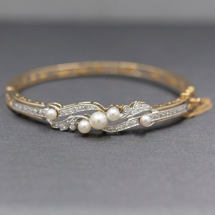 "Exquisite Art Deco Cultured Pearl and Diamond Bangle Bracelet in 14k Yellow Gold This stunning bracelet is a perfect period piece in exquisite condition.  The bracelet features a bangle design with a hinged opening at the side.  The top of the bracelet is encrusted with diamonds and pearls.  The pearls and cultured and measure 6.14mm (largest and 3.84 (smallest).  The design features single cut round diamonds, thirty two of them.  The stones are VS/SI clarity and are G/H color.  They measure 1. Elegant Hallmarked Bangle For Formal Events, Classic Diamond Bracelet With Oyster Style For Wedding, Classic Diamond Oyster Bracelet For Wedding, Antique White Gold Bracelets For Anniversary, Formal Diamond Bangle Bracelet With Oyster Detail, Heirloom Gold Bracelet For Wedding With Jubilee Detail, Heirloom Gold Jubilee Bracelet For Wedding, Heirloom Jubilee Gold Bracelet For Wedding, Antique Diamond Accented Bracelets For Anniversary