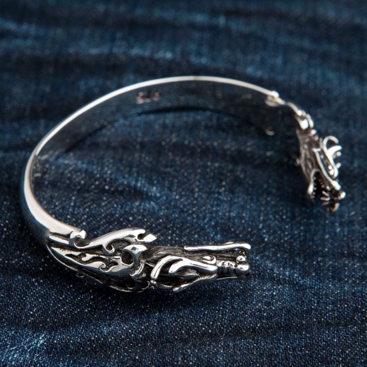 925 Sterling Silver Dragon Cuff ~Brand New   Solid high-quality 925 sterling silver;  925 stamp inside the band;  Bracelet weight: 48 grams;  Adjustable for wrists from 7” to 8”;  Exclusive hand-crafted piece.   The luxury of gothic jewelry is now available to everyone with the exclusive sterling silver dragon cuff by Bikerringshop. We take a popular Gothic motif, the dragon, and incorporate it into amazing dangle bracelet with grace and dexterity. At the same time, we reduced unnecessary detail Dangle Bracelet, Double Dragon, Silver Dragon, Dragon Head, Band Bracelet, Sterling Silver Cuff, Gothic Jewelry, Silver Cuff, The Dragon