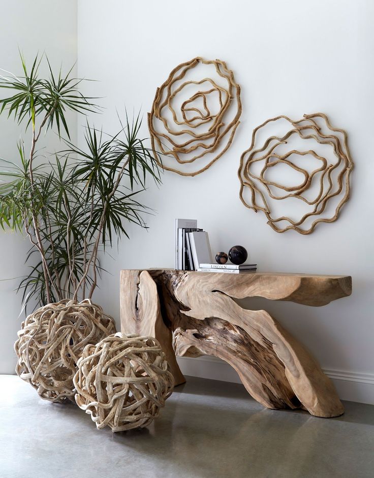 a wooden table sitting next to a potted plant