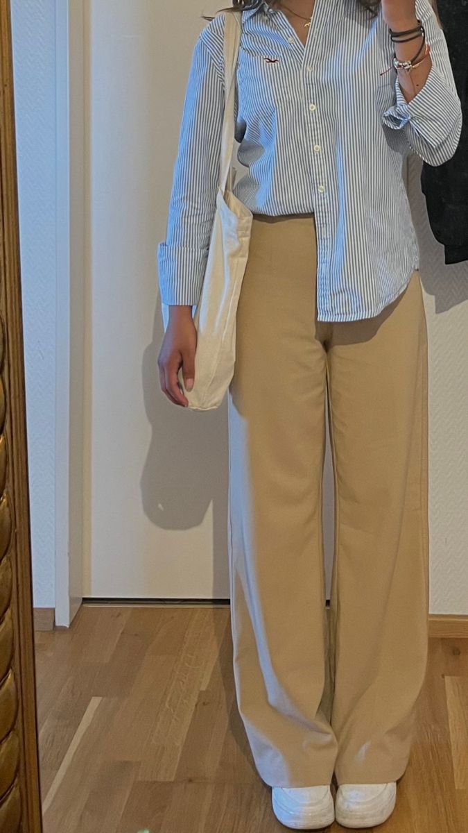 Tote bag, white shoes, casual outfit, trousers, buttoned shirt Full Beige Outfit, Outfits With Beige Trousers, Tomboy Assesories, Western Fashion Outfits Casual, Beige Pants Outfit Women Summer, Beige Trousers Outfit Summer, Cream Pant Outfits Women, Beige Shirt Outfits Women, Cream Pants Outfit Women