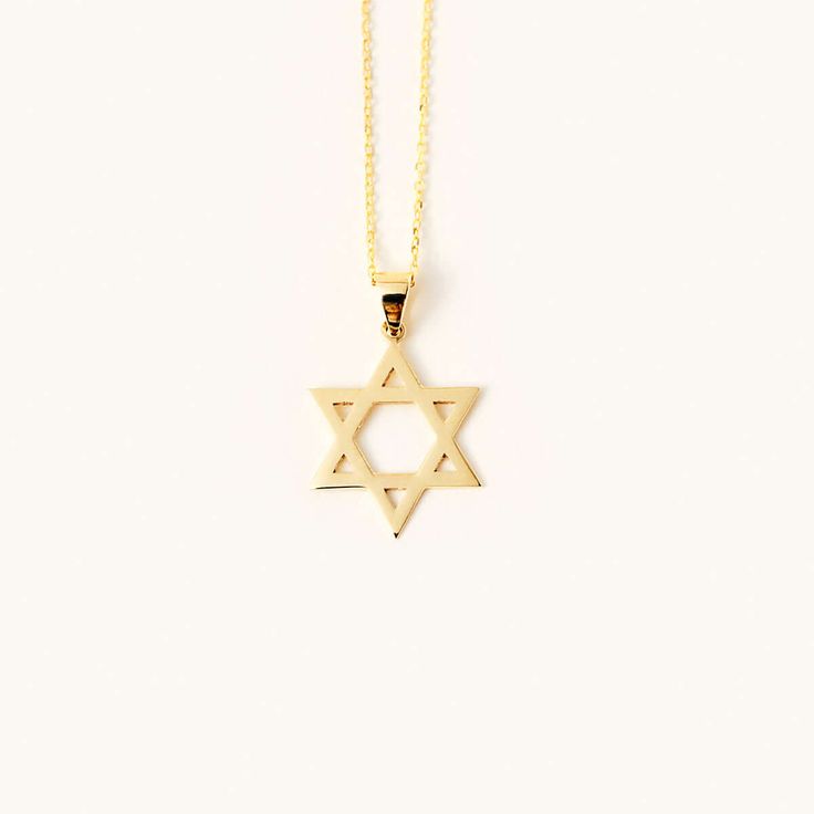 The Star of David Necklace in 14K Gold is a stunning piece of jewelry that beautifully showcases your faith. Made from 14k solid gold. This necklace serves as a meaningful symbol of your beliefs and is a great gift for yourself or a loved one. Stand out with this elegant and meaningful necklace that effortlessly combines style and spirituality. 14k solid gold handcrafted necklace 100% ethical sourced jewelry Material: 14k Solid Gold Pendant Height: 16 mm / 0.61 inch Pendant Width: 13 mm / 0.51 i 14k Gold Star Of David Jewelry Gift, Spiritual Yellow Gold Star Of David Necklace, Gift 14k Gold Star Of David Necklace, 14k Gold Star Of David Necklace Gift, Gold Star Of David Necklace In 14k Gold, 14k Yellow Gold Star Of David Necklace, Minimalist 14k Gold Star Of David Necklace, Symbolic 14k Gold Star Of David Jewelry, Spiritual 14k Gold Star Of David Jewelry