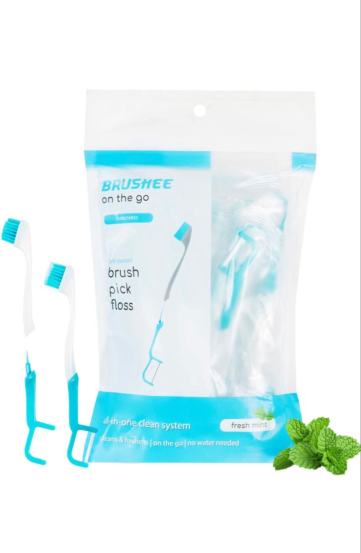 two toothbrushes in a bag with mint on the side