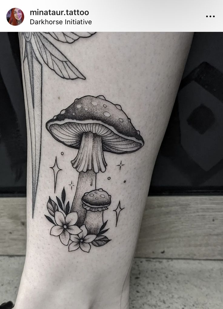 a black and white mushroom tattoo on the leg