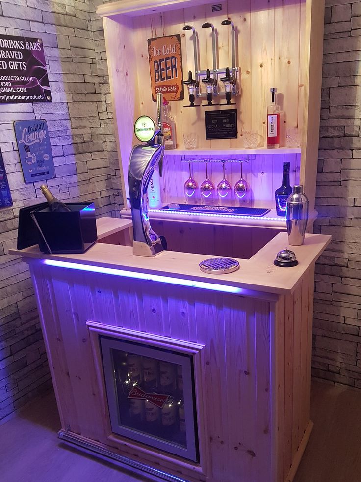 a small bar made out of pallet wood with purple lights on the front and back