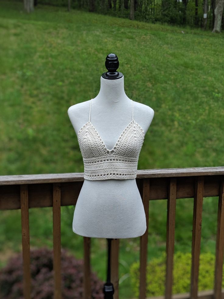 This crochet crop top that is handmade with beige cotton yarn is the perfect crochet bralette to add the perfect boho touch to your wardrobe. This also makes a great gift for a girlfriend or friend. It can be worn in different styles under a kimono, a blouse, pair it with shorts, skirts or jeans it will look fantastic for a festival, a walk at the beach or a pool party. -Cotton Yarn -Handmade -Ties up around neck and to back BUST not LINED or PADDED  Material care: Hand wash in cold water; Lay f Fitted Triangle Beige Crop Top, Fitted Beige Triangle Crop Top, Beach Lace Crop Top Bra Friendly, Beach Lace Crop Top, Bra Friendly, Beach Crop Top In Lace That Is Bra Friendly, Beach-ready Bra-friendly Lace Crop Top, Fitted Beige Crochet Top Handmade, Fitted Cropped Beige Crochet Top, Beige Fitted Crochet Crop Top