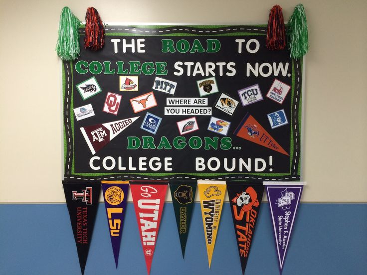 a bulletin board with college banners and tassels on it