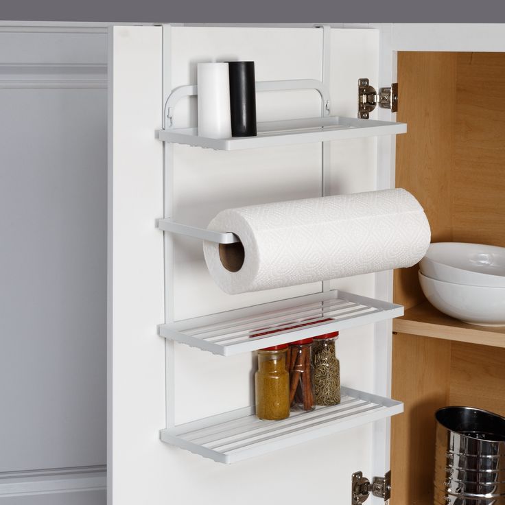 a white shelf with two rolls of toilet paper on it and some spices next to it