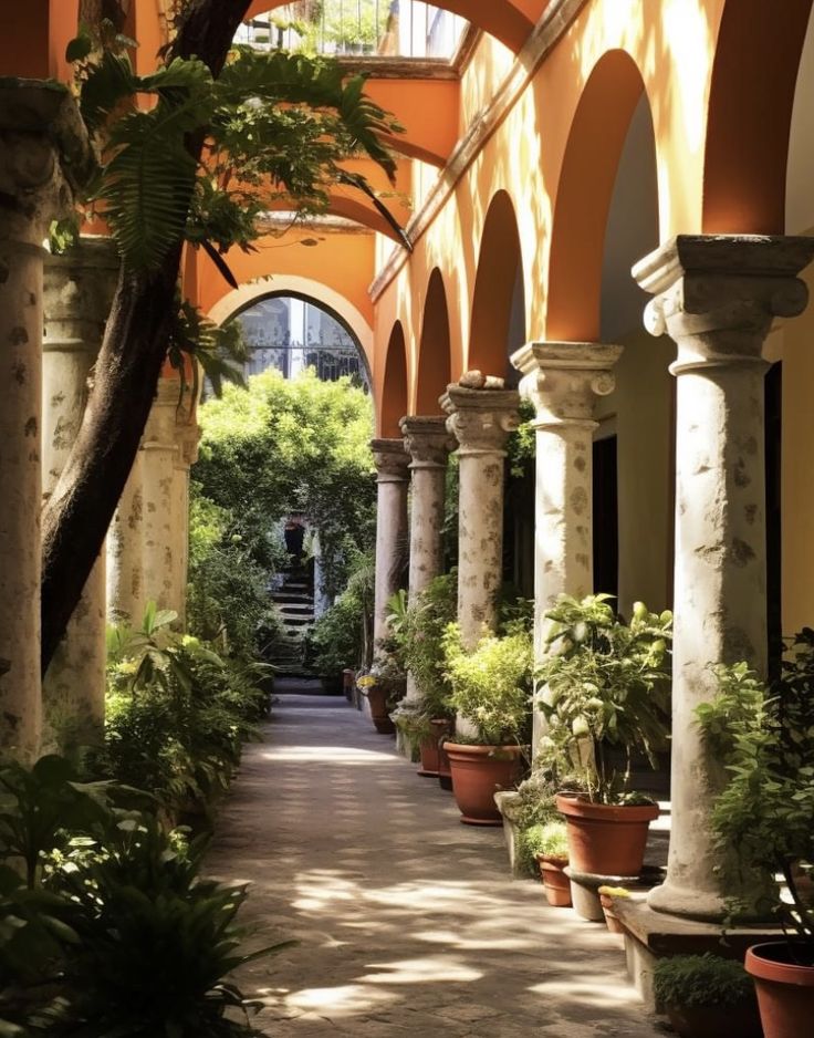 an arched walkway with potted plants and trees