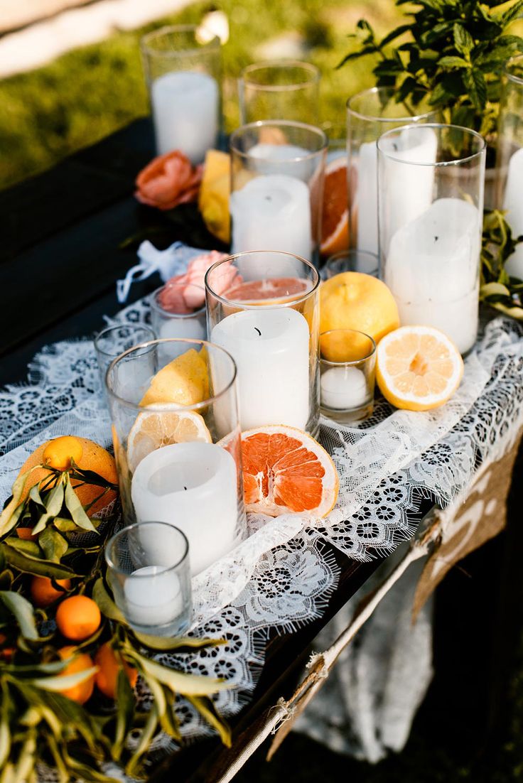 a table topped with lots of candles and oranges