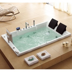 an indoor jacuzzi tub in the middle of a living room with chairs around it