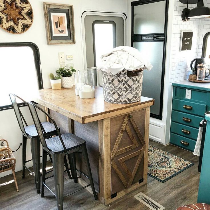 a kitchen island in the middle of a room with chairs and other items on it