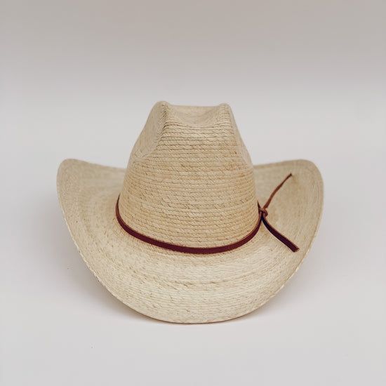 The Meadow straw cowboy hat is lightweight, durable. It's the prefect summer hat for a day at the beach or while cruising around town. These hats are individually handcrafted with sustainable palm leaf and naturally tanned leather by artisans in Guerrero, Mexico, in a fair trade environment. Each hat is unique and may vary in size and color and have small imperfections. -Crown height: 5.0", Brim length: 4.0" curved up brim -Removable naturally tanned brown leather band***leather band may vary fr Natural Handwoven Straw Hat For Rodeo, Toquilla Straw Sun Hat With Curved Brim For Ranch, Handwoven Natural Straw Hat For Rodeo, Handwoven Flat Brim Panama Hat For Rodeo, Handwoven Toquilla Straw Hat For Rodeo, Natural Color Western Style Brimmed Hat, Toquilla Straw Hat With Curved Brim For Ranch, Natural Western Brimmed Hat, Handwoven Straw Hat For Rodeo