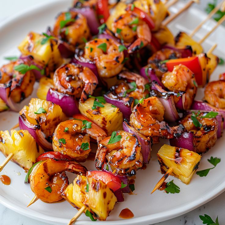 grilled shrimp and pineapple kabobs on a white plate with garnish