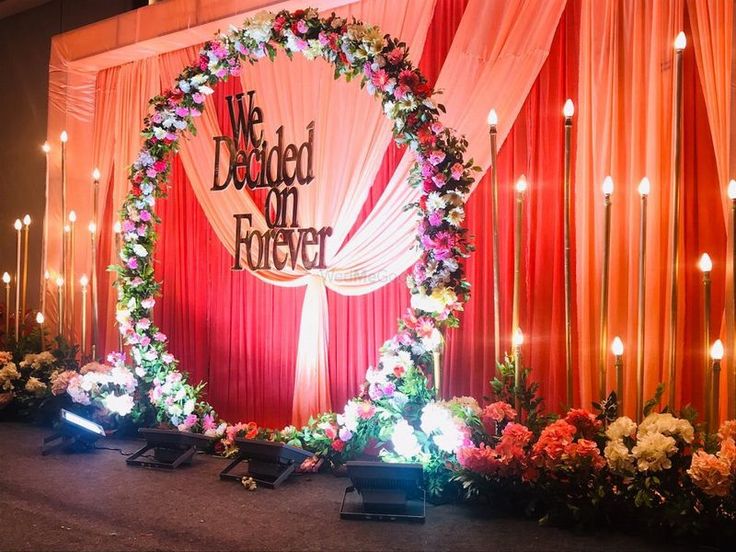 a decorated stage with flowers and candles