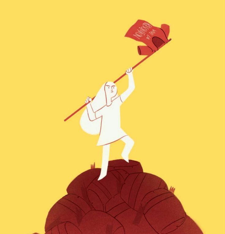 a man holding a red flag on top of a mountain